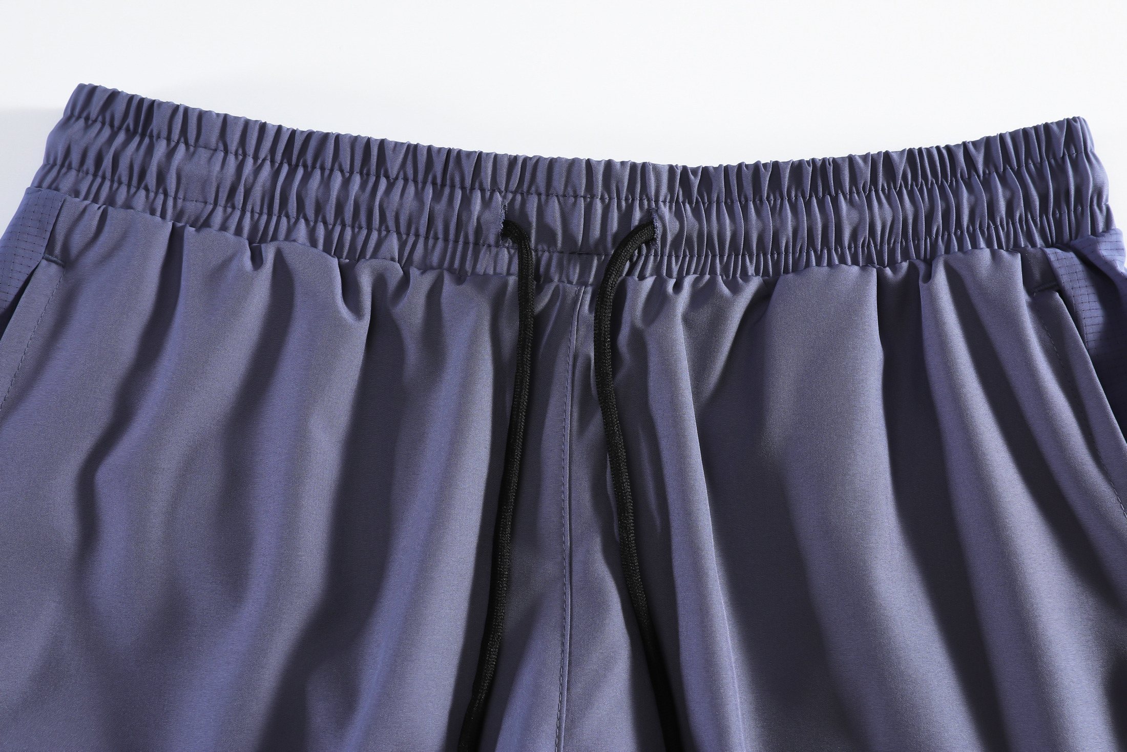 Drawcord waistband and dual side-pocket construction