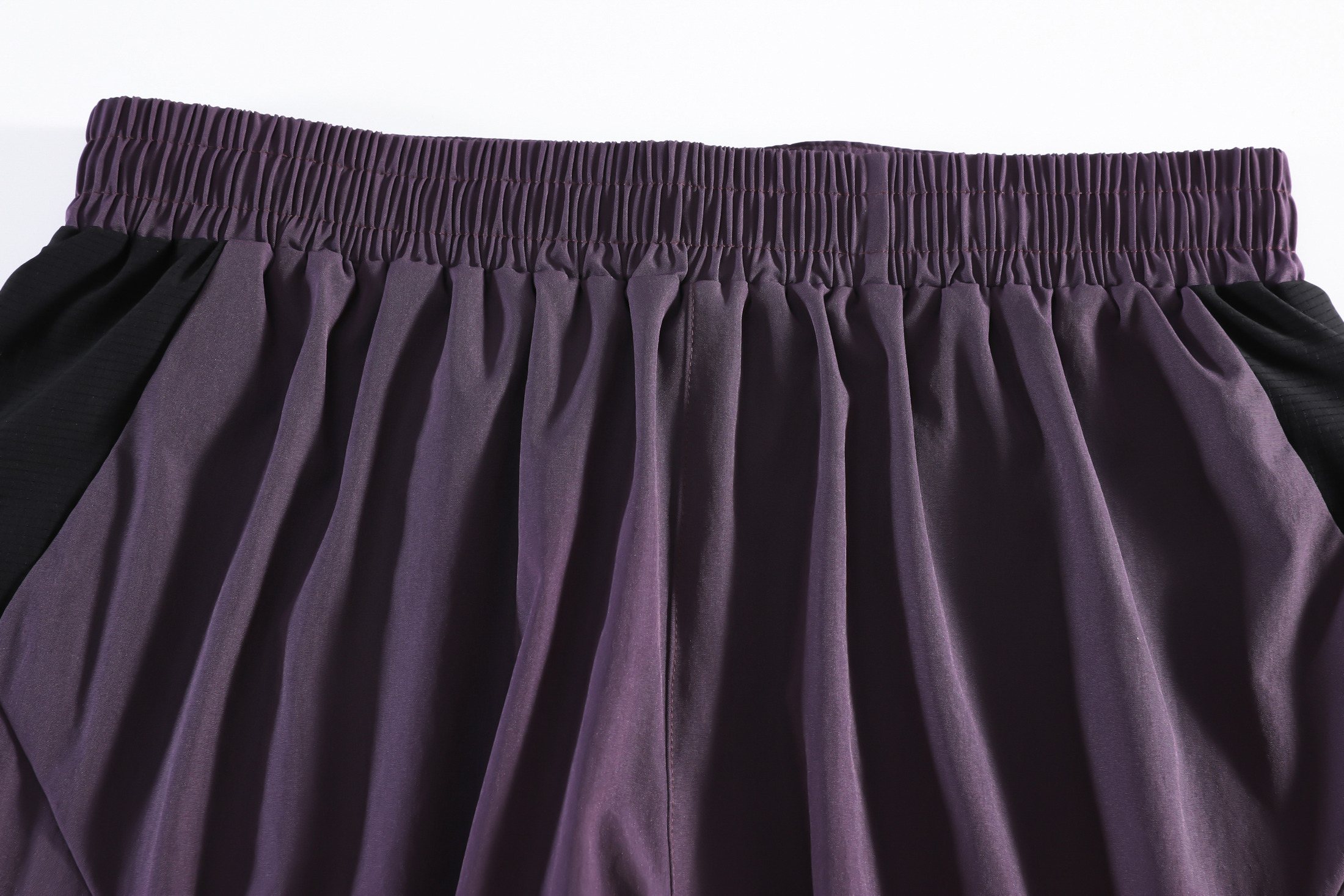 Drawcord waistband and rear-pocket trail construction