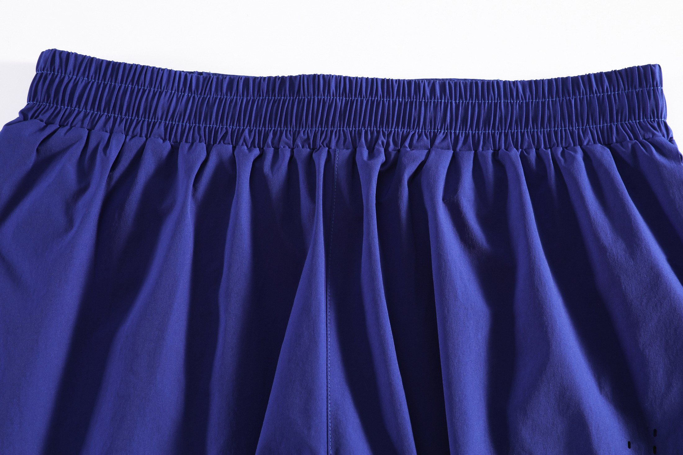 Drawcord waistband and hidden rear-pocket construction