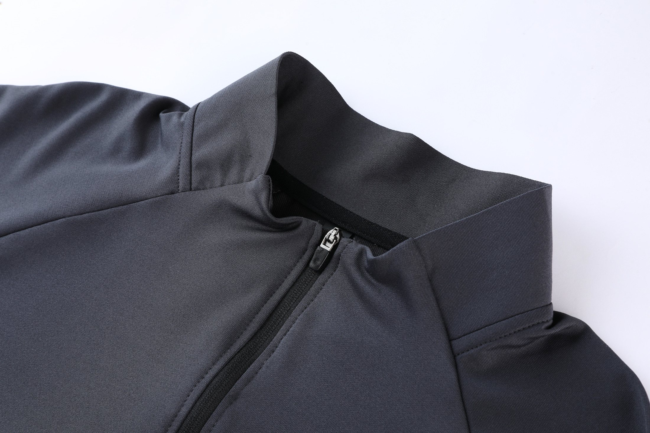 Stand collar, quarter zipper, and reflective shoulder construction